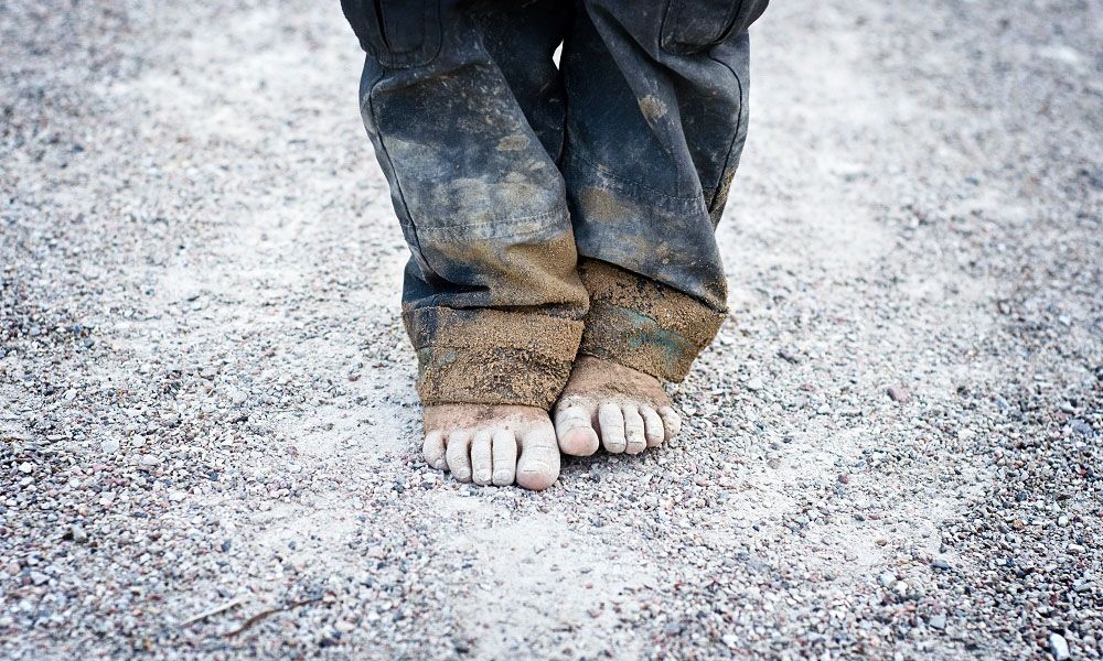 Bare and dirty feet of baby