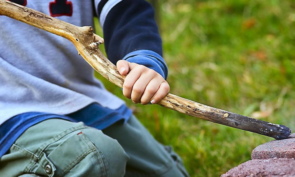 Boy gripping stick