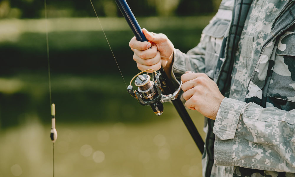 Man is holding a fishing rod