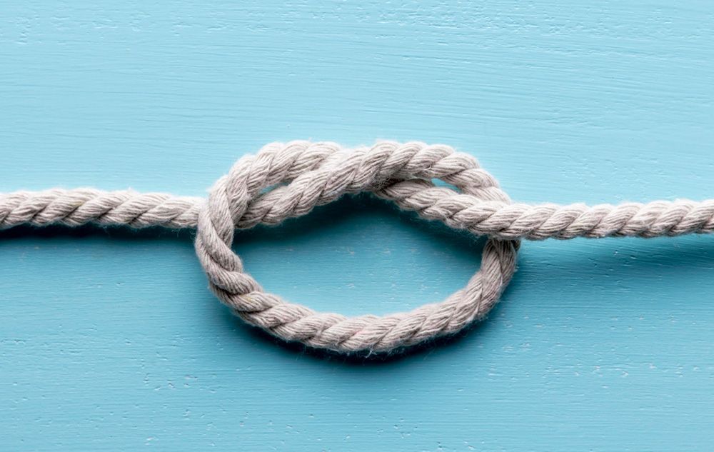 Twine strong white rope with knot flat lay
