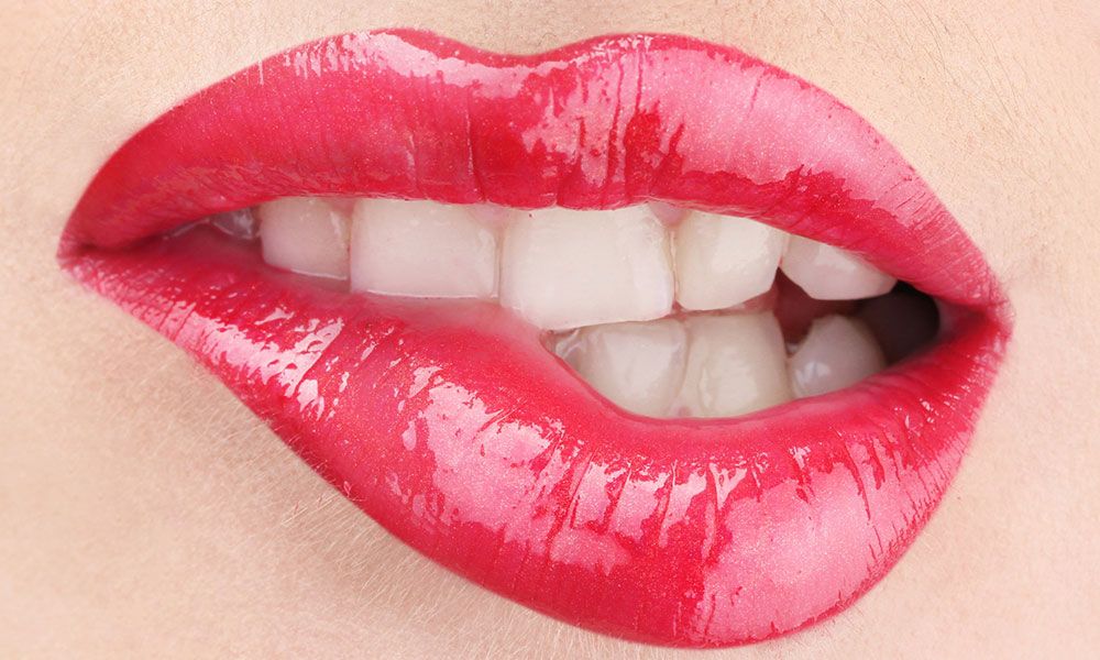 Woman bites red lips