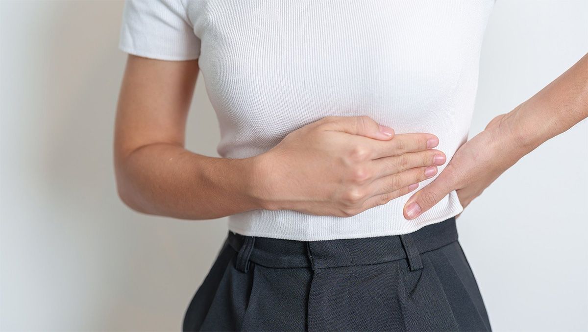 Woman holds her spleen
