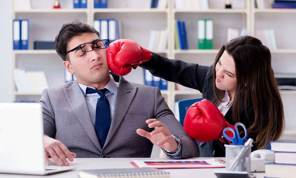 Woman in boxing gloves hit man