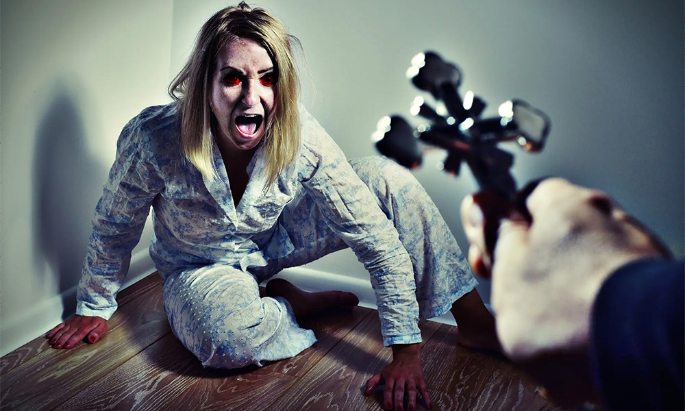Woman with red eyes sitting in the corner screaming at the cross